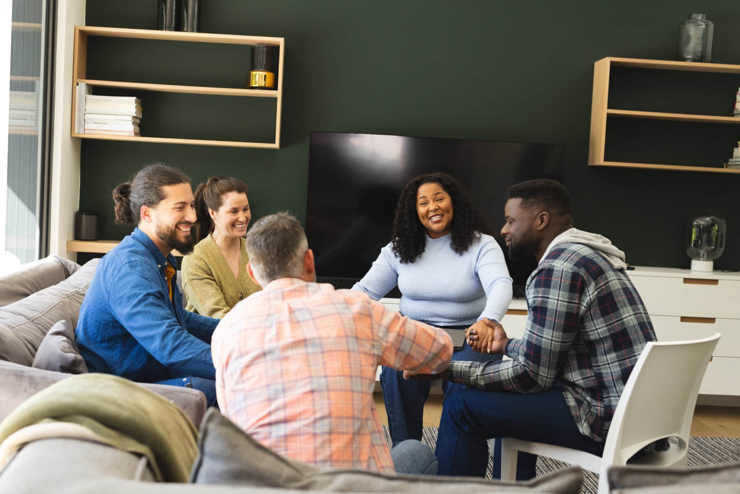 Group of men and women talking in a group about What is the First Step in Recovery.